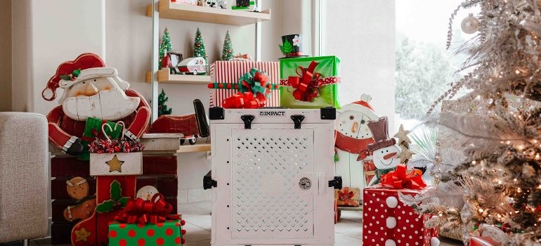 Festive Christmas decor with gifts and a dog crate.