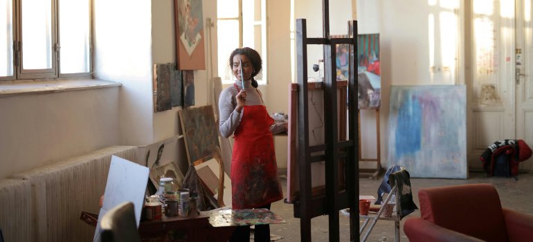 An artist working on an easel happy after finding the best storage solutions for artists and creatives in Brooklyn