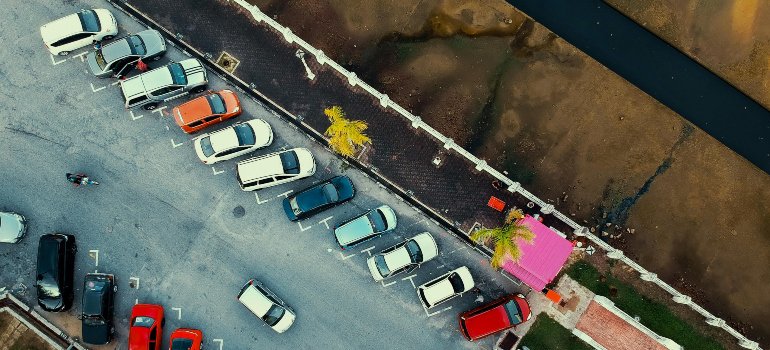 Cars in a parking lot as they are the types of vehicles most commonly stored in NYC.