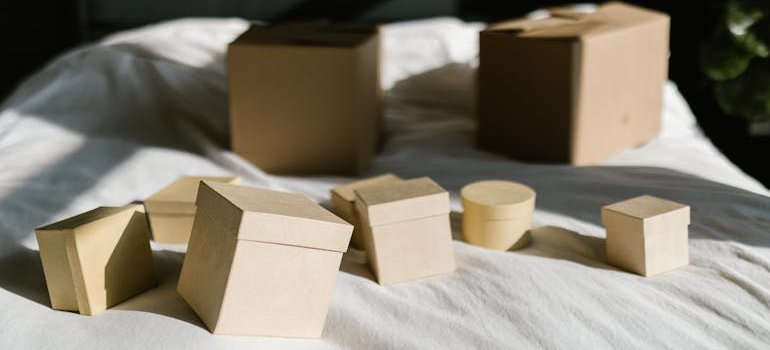 Boxes on the bed to pack items after finding storage solutions for growing families in the Bronx.