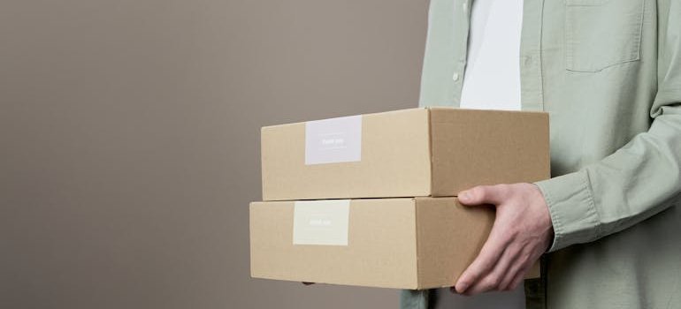 A person holding a couple of boxes.