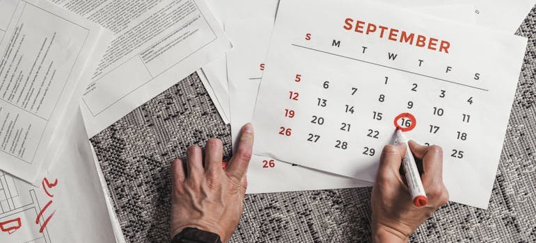 A person marking adate on a calendar.