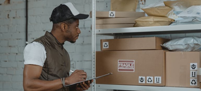 A person checking the items inside of a storage unit to safeguard high-value items in storage.