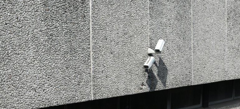 A security camera on a concrete wall.