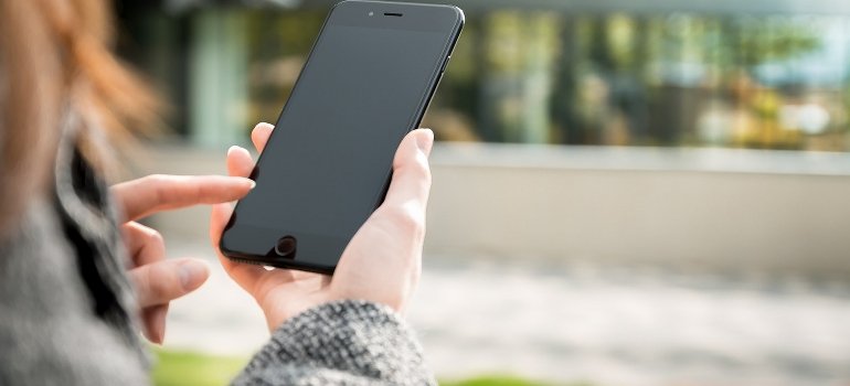 A woman is using a cellphone.