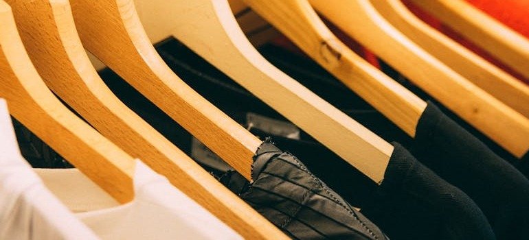Clothing on hangers as some of the items to keep in storage during winter.