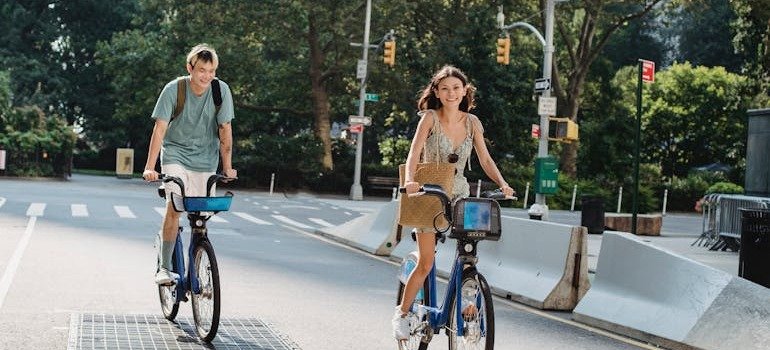 A couple enjoying Gen Z-friendly living in NYC by riding bikes.