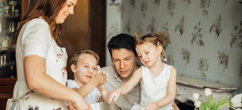 A young family having fun in the kitchen.