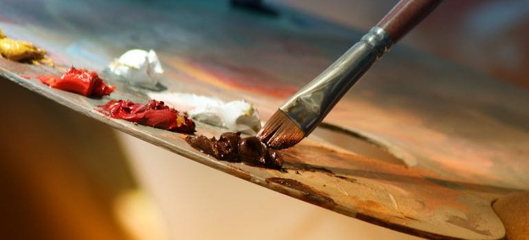 A palette with colors and a brush.