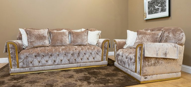 Velvet sofas arranged elegantly in a warm-toned living room.
