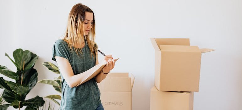A young woman keeping track of her items.
