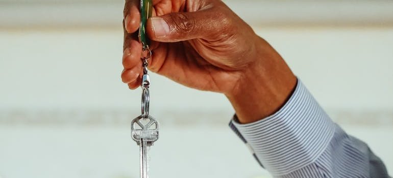 A person holding the keys to the apartment at the start of living in Riverdale.