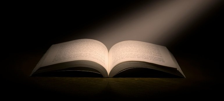 An open book under dramatic lighting, conveying the power of storytelling and learning.