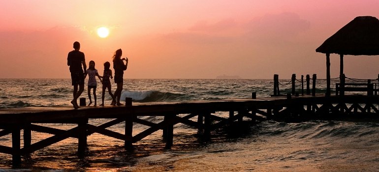 A family enjoying a beautiful sunset find peace knowing their belongings are securely stored in short-term storage for busy young families.