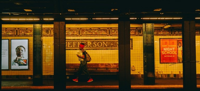 Person walking on a subway platform.