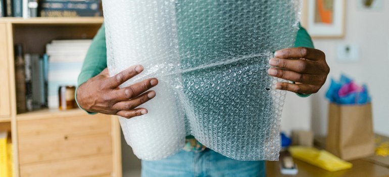 A person holding bubble wrap.