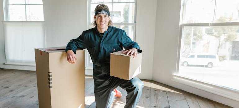 A professional holding two cardboard boxes.
