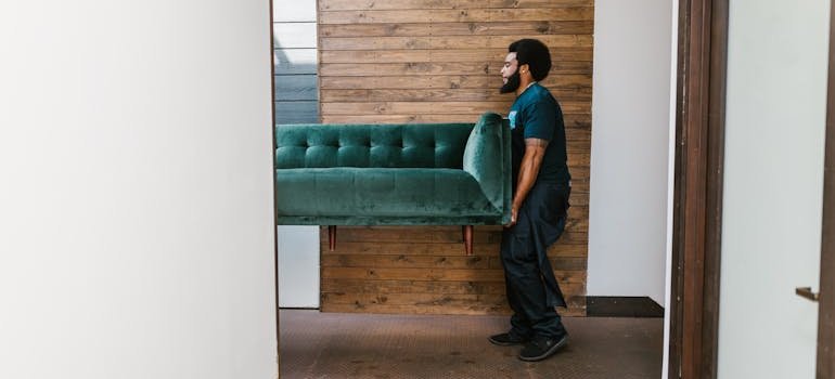A mover moving a sofa