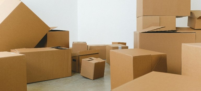 A room filled with boxes stacked on the floor, symbolizing the need for low storage costs in NYC.