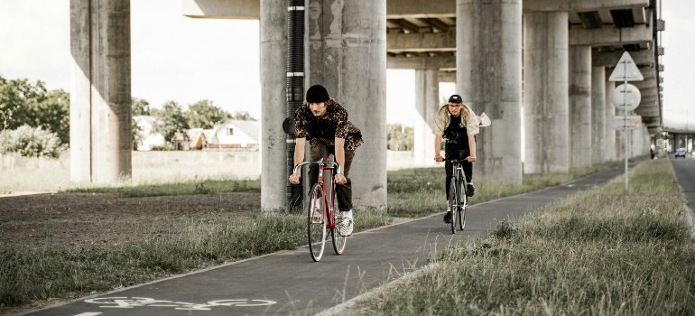 two men riding bikes enjoying ar-free living in Brooklyn