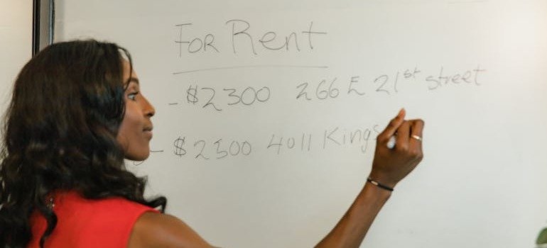A woman calculating the cost of setting up a remote office in the Bronx.