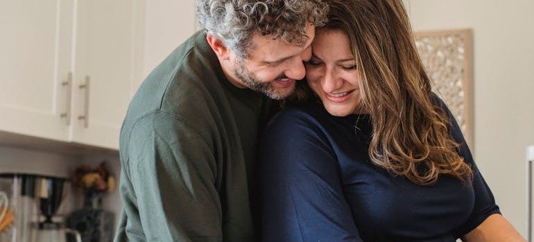 A man and woman hugging.
