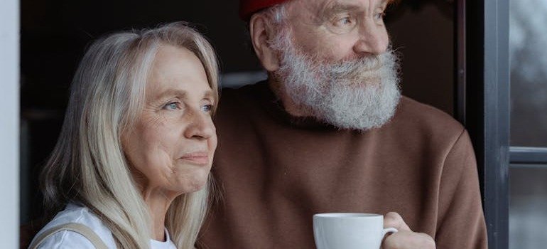 An elderly couple looking into the distance.