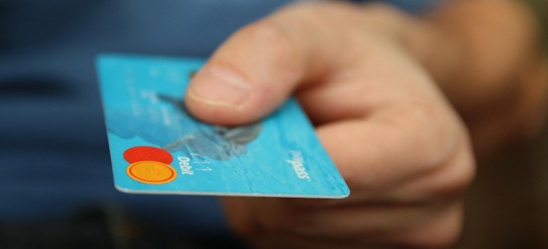 a person holding a debit card