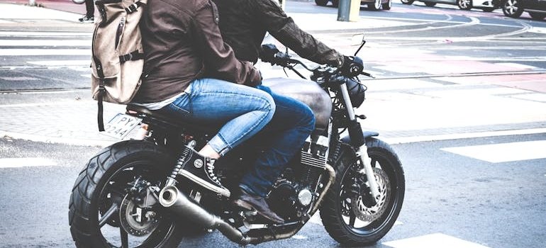 Couple riding a motorcycle on the street.