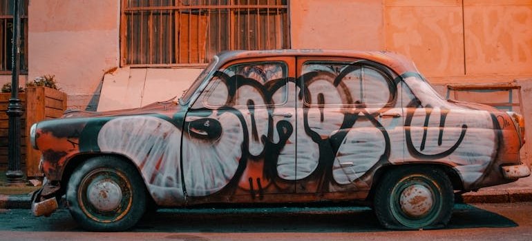 Vandalized car parked on the street.