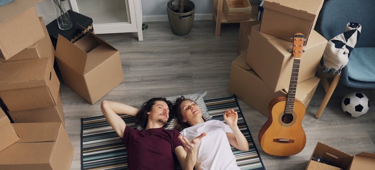 A couple lying on the carpet.