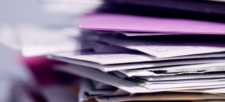 Pile of documents that are important things you need before renting an apartment in NYC