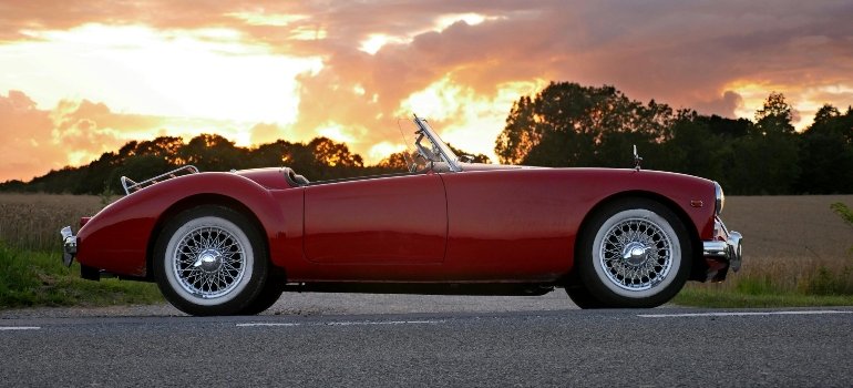Red car parked at sunset