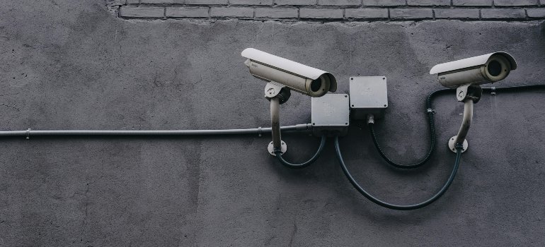 Two security cameras symbolizing why storing items away is better than cluttering your home for safety reasons