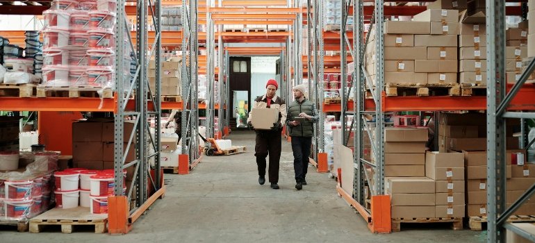 Warehouse workers managing large inventory stockpiles where storage location affects pricing.