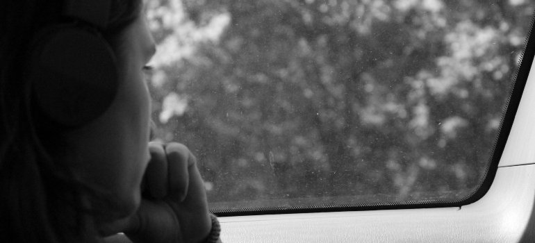 Person looking through a window of a car.