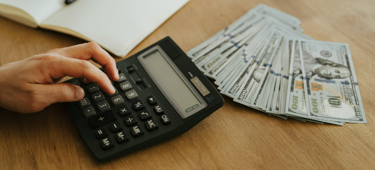A person calculating the costs for Manhattan storage pick-up.