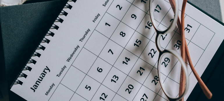A calendar and a pair of classes on it.