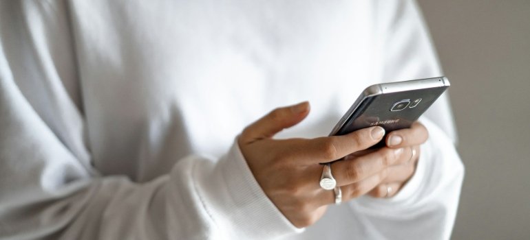Person using a phone to help them combat nostalgia after leaving NYC.