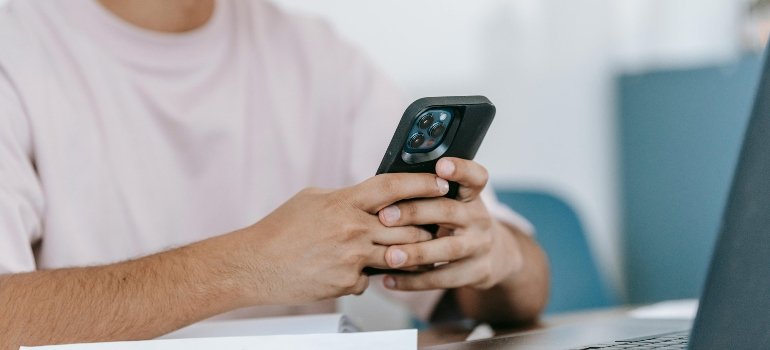 A person using a smartphone to discover how to find reliable storage units.