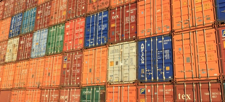 A grid of colorful shipping containers stacked in an industrial yard, symbolizing high-volume logistics and a new way to store your belongings.