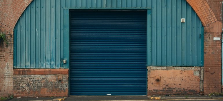 A rugged blue warehouse door, showcasing a reliable option for storing your valuables the right way.