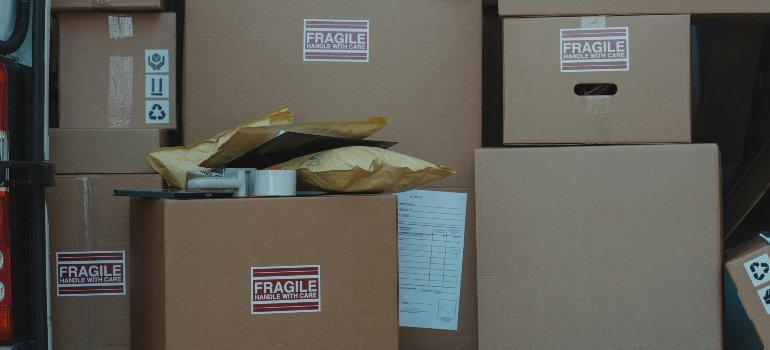Labelled cardboard boxes in a van on ther way to one of good storage units.
