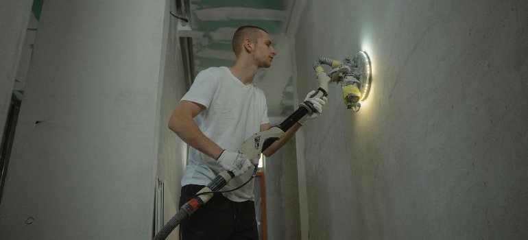 A man involved in apartment renovation after obtaining all the necessary permits for apartment renovation in NYC.