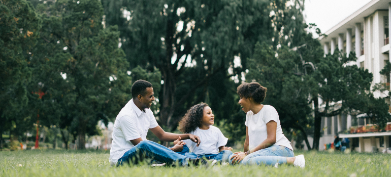 Parents enjoying the time in the park while raising a family in Queens