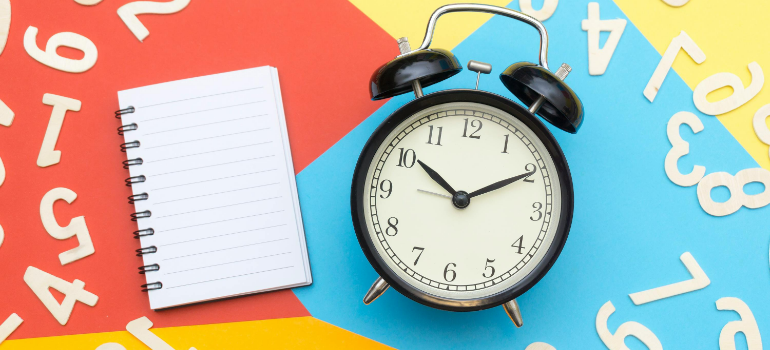 A notebook and a clock because proper preparation and timing matter when moving to Manhattan with a newborn.