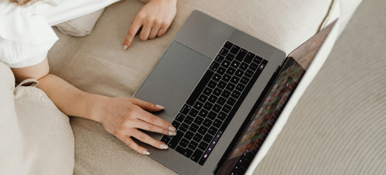 A person using a laptop to find out how to choose a mini storage unit properly.