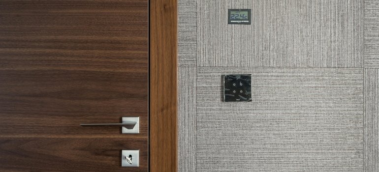 A sleek wooden door with digital keypad lock and temperature display, ideal for those understanding why a climate controlled unit matters.