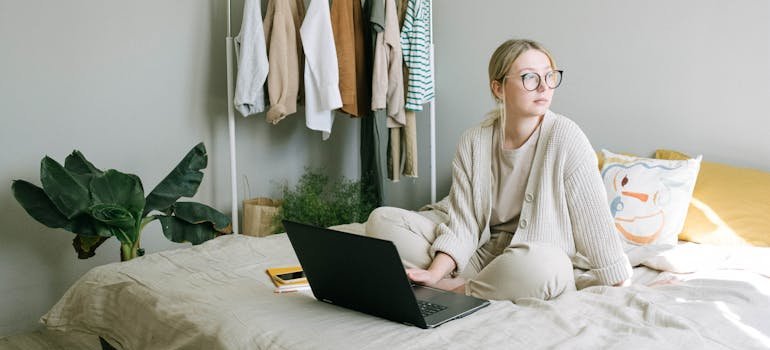A person doing their job from their bed.