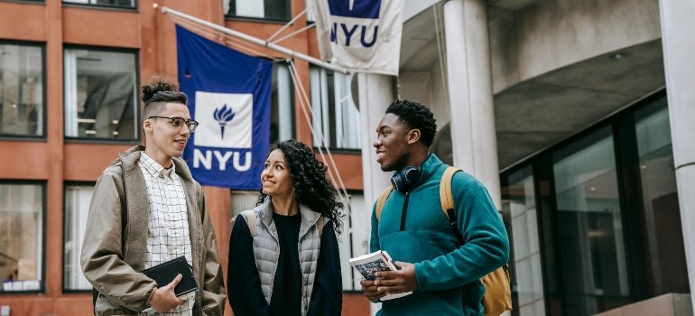 Group of students outside NYU discussing class projects and sharing tips to prevent student storage mistakes.